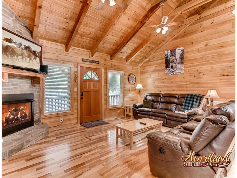 Living room with leather furniture, gas fireplace and flat screen TV with cable